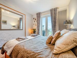 a bedroom with a large bed with a large mirror at Hindscarth Apartment - Uk39610 in Davidstow