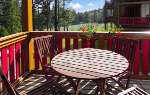 a wooden table and two chairs on a porch at Awesome Apartment In Pohorje With Wifi in Pohorje