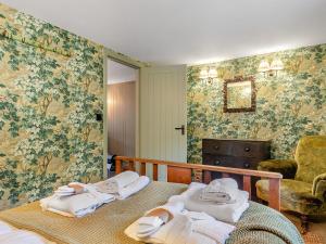 two beds in a room with towels on them at Beiras Garden, Knockendoch in New Abbey