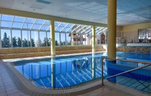 a large swimming pool in a large building at Lovely Apartment In Pohorje With Indoor Swimming Pool in Hočko Pohorje