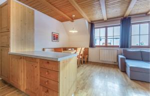 a kitchen and living room with a couch and a table at Lovely Apartment In Pohorje With Indoor Swimming Pool in Hočko Pohorje