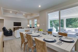 a dining room and living room with a table and chairs at Luxe Rehoboth Beach House with Community Pool and Gym! in Rehoboth Beach