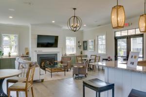 a living room with a table and a fireplace at Luxe Rehoboth Beach House with Community Pool and Gym! in Rehoboth Beach