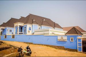 a blue building with a motorcycle parked in front of it at HOTEL D RITZ in Aba Adi