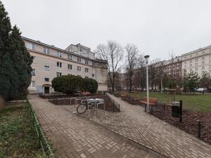 a bike parked on a brick sidewalk next to a building at Bonifraterska Papaya Apartment in Warsaw