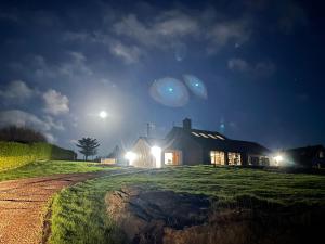 een huis 's nachts met twee planeten in de lucht bij Leaba B&B in Glengarriff