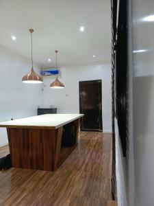 a kitchen with a white counter and wooden floors at Aquaoceans Apartments in Lagos