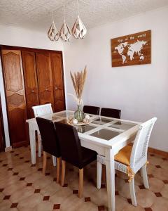 a dining room with a white table and chairs at Appartement chez Eline in Les Angles Gard