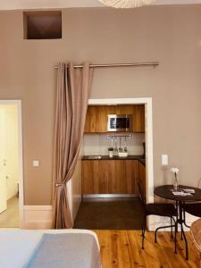 a bedroom with a bed and a table and a microwave at bnapartments Rio in Porto