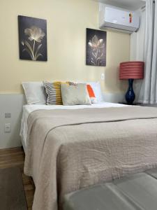 a bedroom with a large bed with pillows at Is Liberdade in Sao Paulo