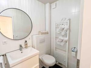 a bathroom with a sink and a toilet and a mirror at City Apartments Gerlingen in Gerlingen +12 photos