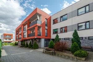 an apartment building with a bench in front of it at Apartment Kozielska z pięknym ogrodem i tarasem in Gliwice