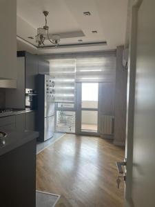 a kitchen with a hard wood floor and a refrigerator at Blue Residence Baku in Baku