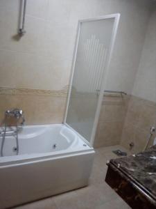 a bathroom with a bath tub with a shower at Vacation villa in Sharm El Sheikh on the beach in Sharm El Sheikh