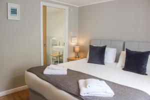 a bedroom with a bed with two towels on it at Sandcastles 15A Fore Street in Salcombe