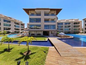 a resort with a swimming pool and a building at EKOARA BEIRA MAR 127 in Porto De Galinhas