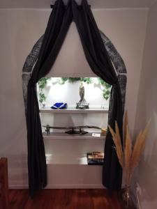 a room with a black curtain on a shelf at Suite privative Le seigneur des Anneaux Arnor in Vertaizon
