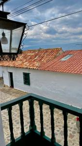 a white building with a red roof and a balcony at Hotel-Apartahotel Boutique Piedra & Luna in Villa de Leyva