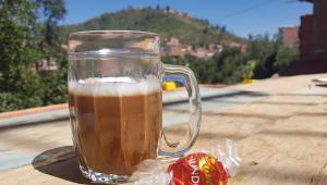 a glass mug of beer sitting on top of a table at Family HOME-Ciclovía Sucre-Bol in Sucre