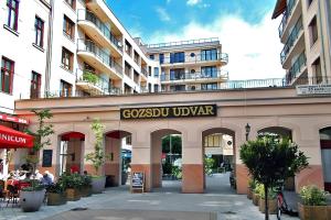 a building with a sign that reads goossu uvar at NOVO Central Apartments in Budapest