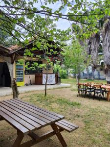 a wooden picnic table in a park with tables at 7 Garden Bungalow / Camping in Kumluca