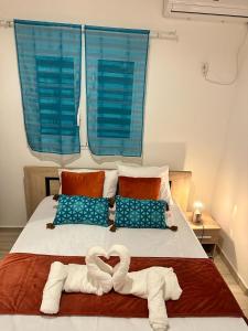 łóżko z dwoma łabędzie wykonanymi z ręczników w obiekcie Lacazavanoo w mieście Baillif