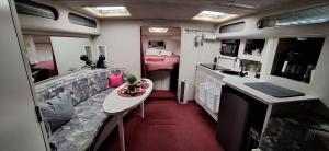 an rv living room with a couch and a table at BLUE SEA BOAT in Vallauris