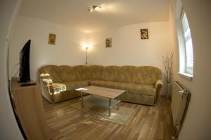 a living room with a couch and a table at Apartments Demec in Kranjska Gora