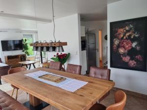 a dining room with a wooden table and chairs at Haus Kreuzeckwiese - Fewo Jübilaumsgrat in Garmisch-Partenkirchen