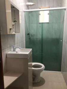 een badkamer met een douche, een toilet en een wastafel bij A casa da Keila - Balneário Camboriú in Balneário Camboriú
