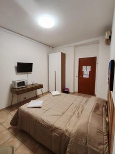 a bedroom with a large bed and a desk at B&B Piazza Ragusa in Rome