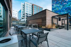 a patio with tables and chairs on a building at Blueground Fenway gym nr food shops BOS-1027 in Boston