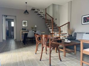 a living room with a table and chairs and stairs at Easy Living 1 & 2 in Kos +35 photos