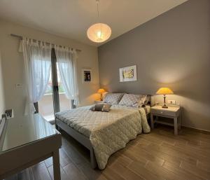 a bedroom with a bed and a table and a window at Easy Living 1 & 2 in Kos Town