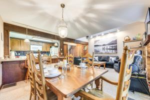 a dining room and living room with a wooden table at Community Beach Access Lake Harmony Townhome in Lake Harmony