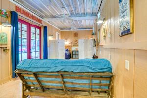 een kamer met een bed met een blauw laken erop bij Inglis Studio Home with Covered Patio and Grill! in Yankeetown