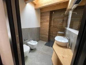 a bathroom with two white toilets and a sink at - Piz Boe - Canazei center app. in Canazei
