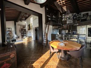 a room with a wooden table and a kitchen at The River View in Florence "Costante Art & Design" in Florence