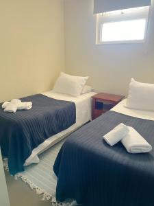 two beds sitting next to each other in a room at Vista Increíble en Laguna Del Mar piso 13 in La Serena