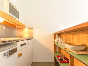 a kitchen with white cabinets and a counter top at Studio Les Arcs 1800, 1 pièce, 5 personnes - FR-1-346-508 in Arc 2000