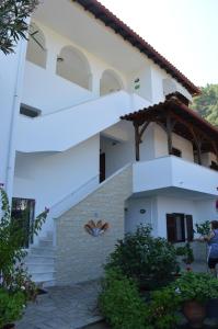 a white house with stairs in front of it at Nikos & Panagiota in Vourvourou