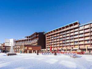 a large building with a lot of chairs in the snow at Studio Les Arcs 2000, 1 pièce, 4 personnes - FR-1-346-467 in Arc 2000