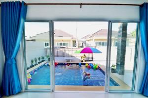 a view of a swimming pool from the window of a house at The Guestvilla644 in Hua Hin