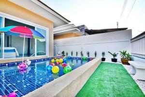 an indoor swimming pool with balls in a house at The Guestvilla644 in Hua Hin