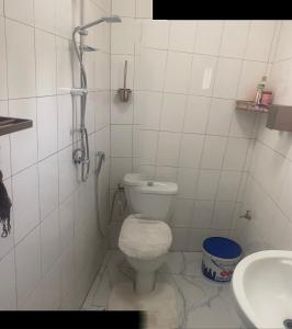 a bathroom with a toilet and a sink at La fierté chambre in Ziguinchor