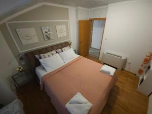 a bedroom with a large bed with two pillows at Apartments Rustika Toscana in Vodice