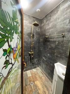 a bathroom with a shower and a shower curtain at Poolside Argel in Argel