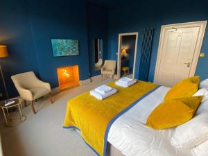 a bedroom with a large bed with a yellow blanket at Fellpack House in Keswick