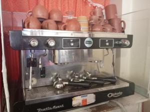 a coffee maker with a pile of pots and pans at Manco Kapac in Copacabana