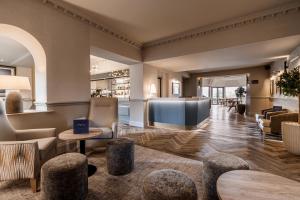 a lobby of a hotel with chairs and tables at Craig Manor in Bowness-on-Windermere